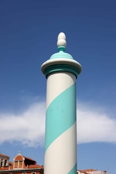 Blue and white wooden mooring pole in Venice. Italy