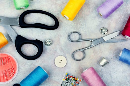 Set sewing kit, scissors, threads, needles and colorful thread. Needlework concept. Top view, flat lay