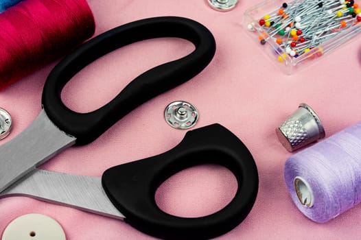 Set sewing kit, scissors, threads, needles and colorful thread. Needlework concept. Top view, flat lay