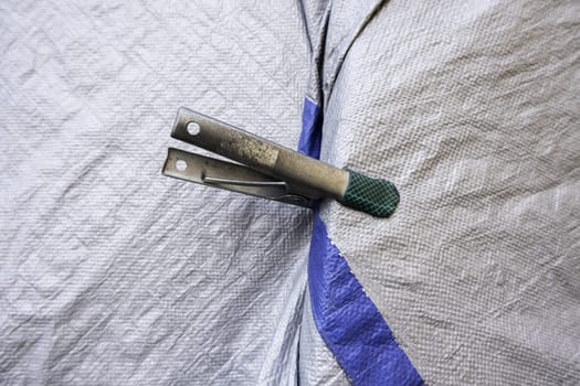 Detail of industrial metal clamp to grab fabric
