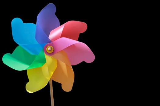 A plastic windmill with a wooden handle. Not a toy for children.