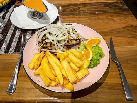 A plate with fries and tratitionel prepared grisly meat.