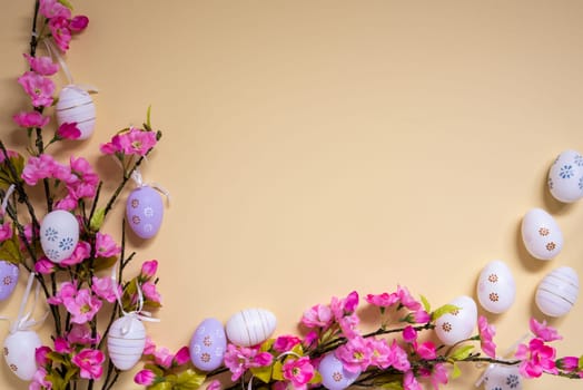 Beige Background With Copy Space For Free Text. Pink And Purple Spring Flower Arrangement With Easter Egg Decoration.