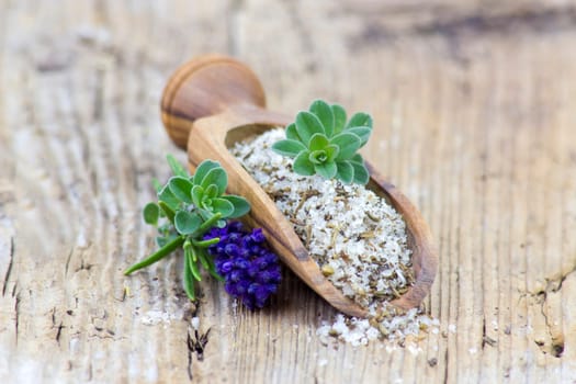 sea salt with fresh herbs - wooden background
