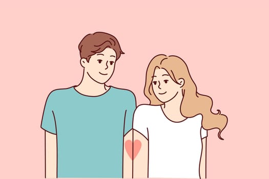 Romantic man and woman with tattoo in form of half heart on hands symbolizing love and desire to be together. Young guy and girl feel affection and want to be together. Flat vector illustration