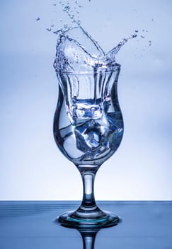 The image of pouring drinking water, into a glass, that makes one feel refreshed on blurred white background, Splashing water, Sparkling water