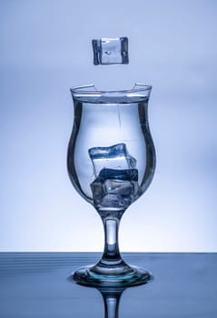 The image of pouring drinking water, into a broken glass, that makes one feel refreshed on blurred white background, Splashing water, Sparkling water, Danger or imminent danger concept