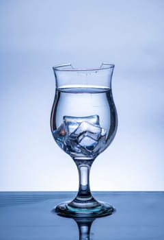 The image of pouring drinking water, into a broken glass, that makes one feel refreshed on blurred white background, Splashing water, Sparkling water, Danger or imminent danger concept