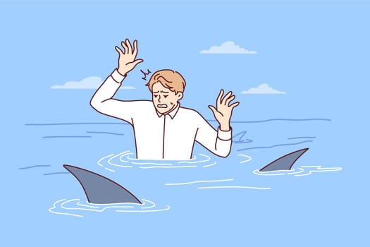 Frightened man in business shirt is in water with sharks and raises hands out of panic. Guy in office clothes with predatory fish symbolizes unfriendly environment in company team. Flat vector design