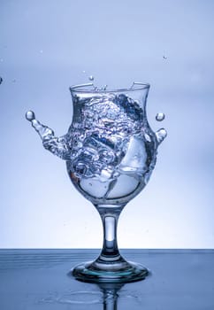 The image of pouring drinking water, into a broken glass, that makes one feel refreshed on blurred white background, Splashing water, Sparkling water, Danger or imminent danger concept