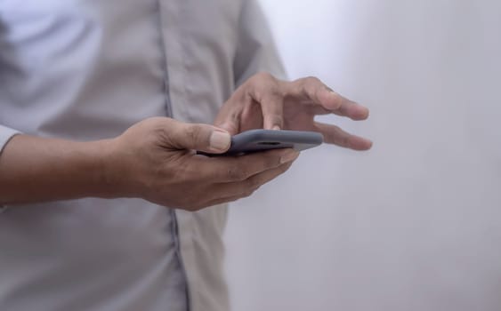 Human using smart phone mobile on blurred background