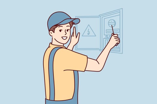 Man electrician is engaged in repair electrical appliances by opening electrical panel. Guy repairman in cap and in overalls carries out installation wiring after major overhaul. Flat vector design