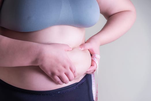 Fat woman, Shape up healthy stomach muscle, and diet lifestyle, to reduce belly concept.