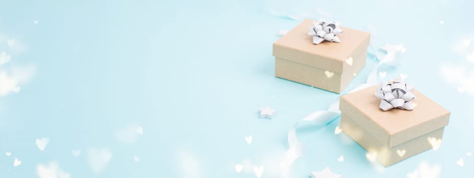 Gift box with ribbon and bow for birthday, mothers day or fathers day, blue bokeh heart lights, surprise for present, greeting card