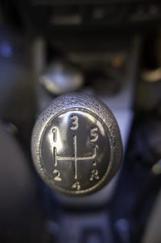 Detail of lever to change gears in a car