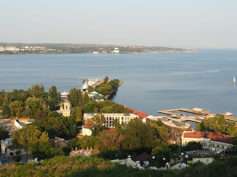 Kerch August 21, 2021 View of the city of Kerch from the observation deck on Mount Mithridat. Houses, trees, Black and Azov seas, seaport. Cove and opposite shore with horizon. Summer evening.
