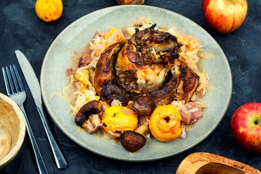 Roasted pork knuckle eisbein with cabbage and apples. Pork leg, German food, top view