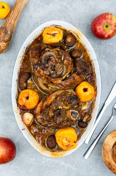Roasted pork knuckle eisbein with cabbage and apples. Pork leg, German food, top view