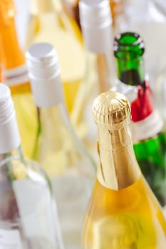 Full and empty bottles of different alcoholic drinks, abuse and alcohol addiction. Alcoholism concept.