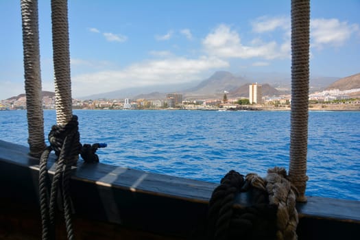 Blurred ship ropes and overlooking Los Cristianos coast on the Canary Island of Tenerife, Spain