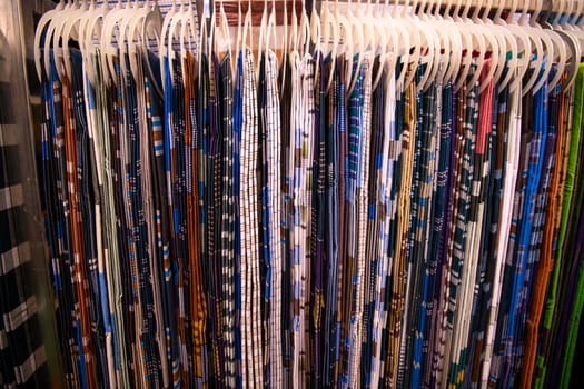 Traditional Bangladeshi men's wear lungi hanging on a rack in a store. texture background