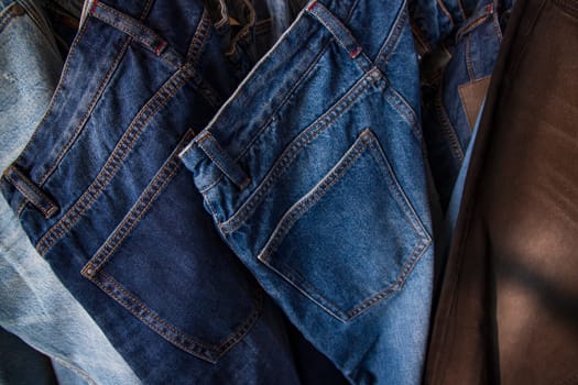 Jeans hanging on a rack in a store, close-up