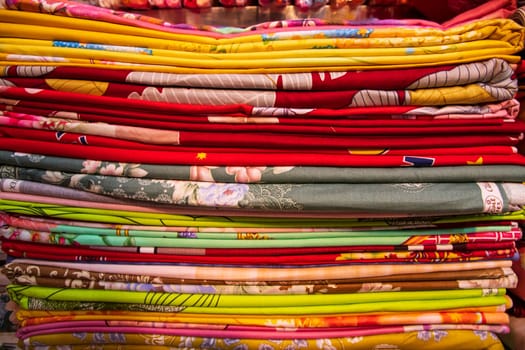 Artistic variety shade tone colors Bed sheets stacked on retail Shop Shelf to sale
