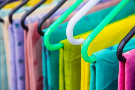 Colorful Saree clothes on hangers in a shop. Selective focus