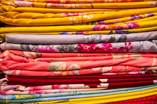 Artistic variety shade tone colors Bed sheets stacked on retail Shop Shelf to sale