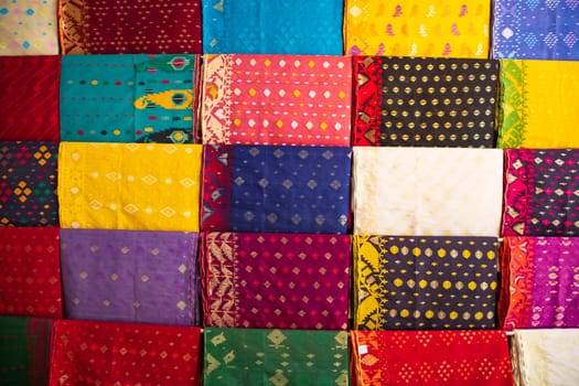 Bangladeshi Women,s Traditional Colorful Jamdani saree hanging in the retail Showrooms. Colorful Jamdani Saree Texture Background