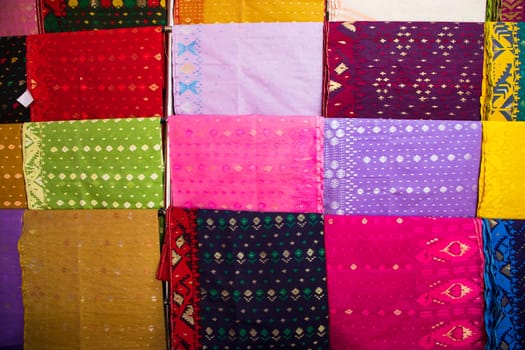 Bangladeshi Women,s Traditional Colorful Jamdani saree hanging in the retail Showrooms. Colorful Jamdani Saree Texture Background