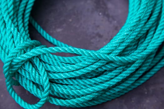 Green rope on dark background. Top view. Copy space for text.