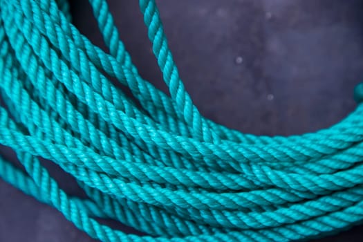 close-up of a green rope on a black background, shallow depth of field