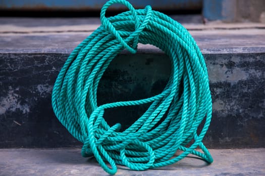 green rope on the cement floor background, vintage color tone.
