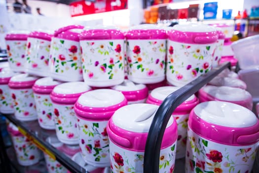 Colorful plastic hot pot lunch box for sale at a supermarket, in Bangladesh.