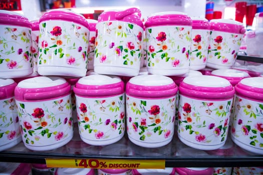 Colorful plastic hot pot lunch box for sale at a supermarket, in Bangladesh.