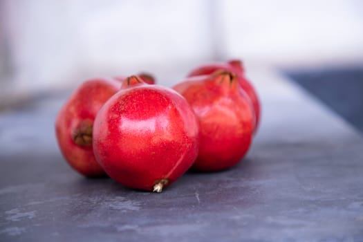 Ripe pomegranate fruit on a dark background close up