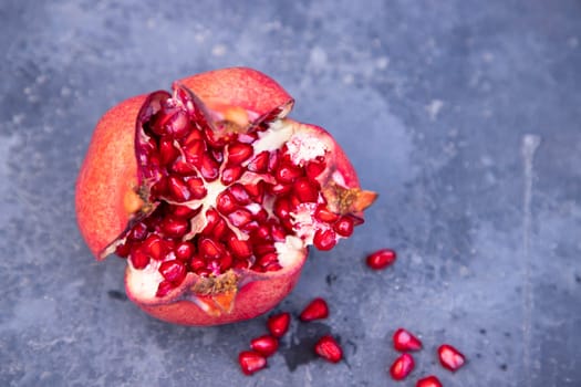 Ripe pomegranate fruit on dark background, closeup