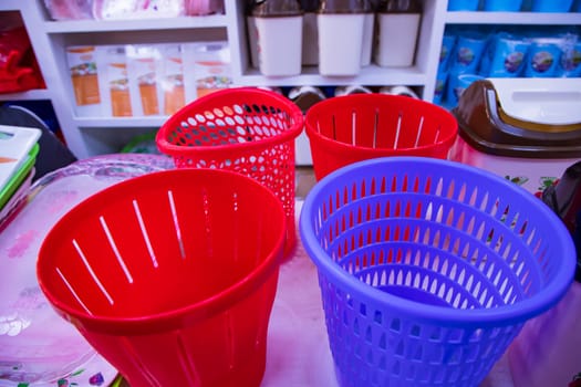 Colorful plastic baskets for sale in a supermarket. The concept of shopping.