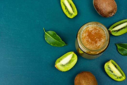 Delicious kiwi jam in a glass jar. Top view, copy space.