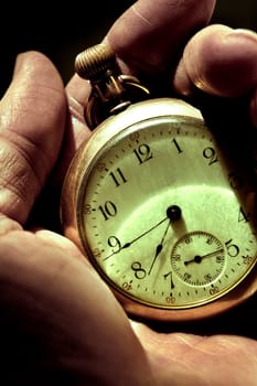 Man looking at his pocket Watch.