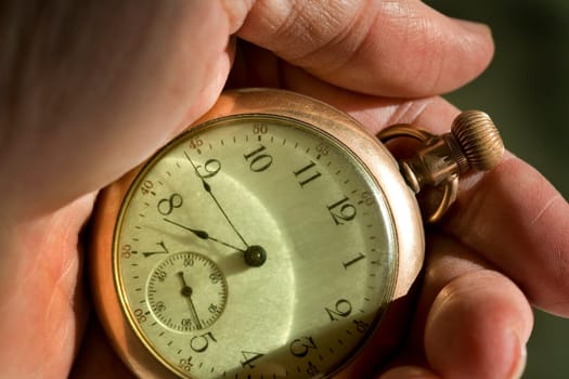 Man looking at his pocket Watch.