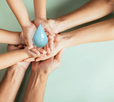 Hands of family holding 3D blue water drop, father mother and child hand stack holding drop clean water together studio shot isolated on blue background, world of water day, CSR, save earth concept