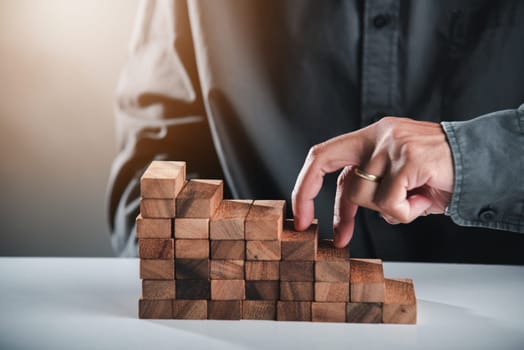 Business two finger symbol walking up on wood blocks shape staircase to climb up career ladder step up stair growth success, prevent collapse or crash concept