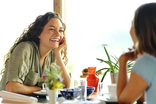 Two happy friends talking in a restaurant