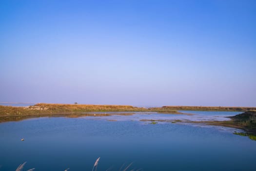 Crystal clear blue water lake landscape view nearby Padma river in Bangladesh