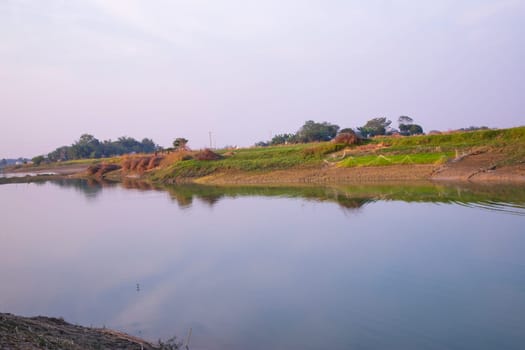 Arial View Canal with green grass and vegetation reflected in the water nearby Padma river in Bangladesh