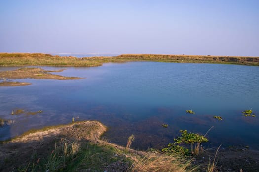Crystal clear blue water lake landscape view nearby Padma river in Bangladesh