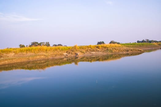 Arial View Canal with green grass and vegetation reflected in the water nearby Padma river in Bangladesh
