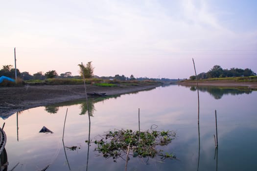 Arial View Canal with green grass and vegetation reflected in the water nearby Padma river in Bangladesh